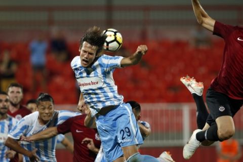 Spartak Subotica's Bojan Cecaric, center, jumps for the ball with Sparta's Uros Radakovic, right, during the Europa League, second qualifying round, first leg soccer match between Spartak Subotica and Sparta Praha at the Karadjordje stadium in Novi Sad, Serbia, Thursday, July 26, 2018. (AP Photo/Darko Vojinovic)