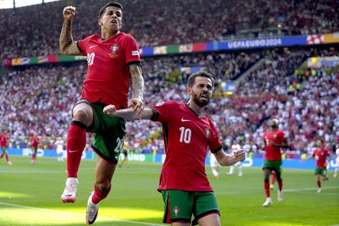Portugal's Bernardo Silva, right, celebrates with Joao Cancelo after scoring the opening goal of his team, during a Group F match between Turkey and Portugal at the Euro 2024 soccer tournament in Dortmund, Germany, Saturday, June 22, 2024. (AP Photo/Themba Hadebe)