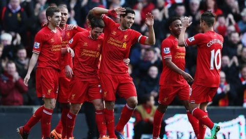 LIVERPOOL, ENGLAND - DECEMBER 21:  Luis Suarez (C) of Liverpool celebrates with team mates after scoring during the Barclays Premier League match between Liverpool and Cardiff City at Anfield on December 21, 2013 in Liverpool, England.  (Photo by Clive Brunskill/Getty Images)