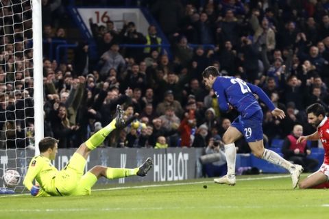 Chelsea's Alvaro Morata, center, scores the opening goal past Nottingham Forest goalkeeper Luke Steele, left, during the English FA Cup third round soccer match between Chelsea and Nottingham Forest at Stamford Bridge in London, Saturday, Jan. 5, 2019. (AP Photo/Alastair Grant)