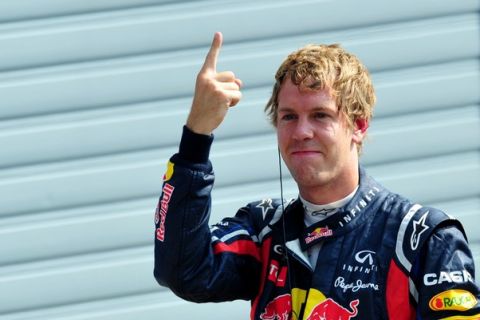 Red Bull Racing's German driver Sebastian Vettel celebrates in the parc ferme  at the Autodromo Nazionale circuit on September 10, 2011 in Monza after the qualifying session  of the Formula One Italian Grand Prix. AFP PHOTO / GIUSEPPE CACACE (Photo credit should read GIUSEPPE CACACE/AFP/Getty Images)