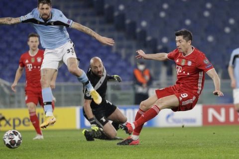 Bayern's Robert Lewandowski, right, scores his side's opening goal during the Champions League round of 16 first leg soccer match between Lazio and Bayern Munich at the Olympic stadium in Rome, Tuesday, Feb. 23, 2021. (AP Photo/Gregorio Borgia)