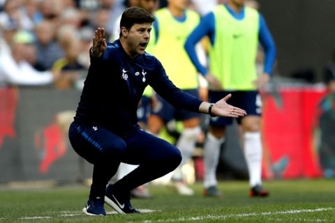 Tottenham Hotspur's manager Mauricio Pochettino gestures as he watches his team play from the side lines during the English FA Cup semifinal soccer match between Manchester United and Tottenham Hotspur at Wembley stadium in London, Saturday, April 21, 2018. (AP Photo/Frank Augstein)