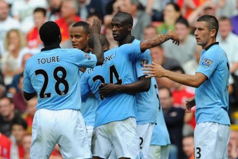 LIVERPOOL, ENGLAND - AUGUST 26:  Yaya Toure of Manchester City celebrates with his team mates after scoring his team's first goal during the Barclays Premier League match between Liverpool and Manchester City at Anfield on August 26, 2012 in Liverpool, England.  (Photo by Michael Regan/Getty Images)