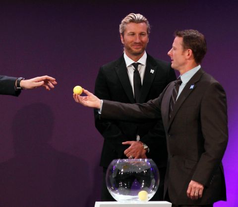 Former Welsh footballer Robbie Savage (C) smiles as former Scottish footballer Kevin Gallacher (R) passes his ball to be opened at the draw for the London 2012 Olympic football tournament at Wembley Stadium in London, on April 24, 2012. Host nation Great Britain will kick off the Olympic football tournament against Senegal at Manchester United's Old Trafford ground on July 26 following the draw made at Wembley. AFP PHOTO / JUSTIN TALLIS (Photo credit should read JUSTIN TALLIS/AFP/Getty Images)