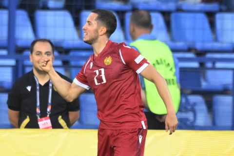 Armenia's Vahan Bichakhchyan, left, celebrates after scoring his side's first goal during the UEFA Nations League soccer match between Armenia and Scotland at the Vazgen Sargsyan stadium in Yerevan, Armenia, Tuesday, June 14, 2022. (AP Photo/Hakob Berberyan)