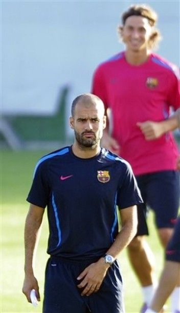 FC Barcelona's coach Pep Guardiola, left, and player Zlatan Ibrahimovic take part in a training session at Joan Gamper training camp, Spain, Friday, Aug. 27, 2010. AC Milan vice president Adriano Galliani says negotiations over the transfer of Barcelona striker Zlatan Ibrahimovic to the Serie A club are ongoing. Milan is reportedly prepared to take the Sweden striker on loan while Barcelona wants to sell him in a full transfer. Ibrahimovic played for Juventus and Inter Milan before joining the Spanish champion last season in a US$66 million deal that sent striker Samuel Eto'o to Inter. He scored 21 goals in all competitions but often struggled to fit into Barcelona's intricate passing schemes. (AP Photo/Manu Fernandez)