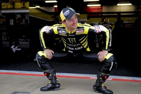 Yamaha's tech 3's  US rider Colin Edwards stretches in the pits during the Moto GP first/second practice session of the Catalunya Grand Prix at the Catalunya racetrack on June 3, 2011, in Montmelo, near Barcelona. AFP PHOTO / JOSEP LAGO (Photo credit should read JOSEP LAGO/AFP/Getty Images)