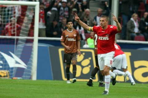 RESTRICTIONS / EMBARGO - ONLINE CLIENTS MAY USE UP TO SIX IMAGES DURING EACH MATCH WITHOUT THE AUTHORISATION OF THE DFL. NO MOBILE USE DURING THE MATCH AND FOR A FURTHER TWO HOURS AFTERWARDS IS PERMITTED WITHOUT THE AUTHORISATION OF THE DFL.
Cologne's striker Lukas Podolski celebrates scoring during the German first division Bundesliga football match 1. FC Cologne vs FC St. Pauli in the western German city of Cologne on September 12, 2010. AFP PHOTO  / PATRIK STOLLARZ (Photo credit should read PATRIK STOLLARZ/AFP/Getty Images)