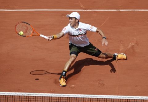 Japan's Kei Nishikori returns the ball to Spain's Fernando Verdasco during their fourth round match of the French Open tennis tournament at the Roland Garros stadium, Monday, June 5, 2017 in Paris. (AP Photo/Christophe Ena)