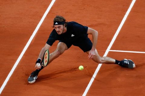 Greece's Stefanos Tsitsipas plays a shot against Russia's Andrey Rublev in the quarterfinal match of the French Open tennis tournament at the Roland Garros stadium in Paris, France, Wednesday, Oct. 7, 2020. (AP Photo/Christophe Ena)