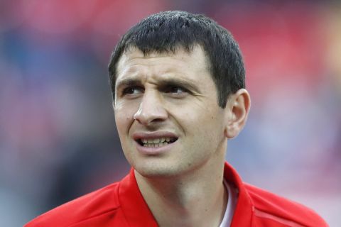 Russia's Alan Dzagoev listens listens to the national anthems before an international friendly soccer match between Russia and Turkey at the VEB Arena stadium in Moscow, Russia, Tuesday, June 5, 2018. (AP Photo/Pavel Golovkin)