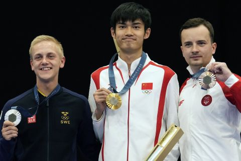 Gold medalist China's Sheng Lihao, center, silver medalist Sweden's Victor Lindgren, left, and bronze medalist Croatia's Miran Maricic pose for a photograph after receiving their medals in the 10m air rifle men's final competition at the 2024 Summer Olympics, Monday, July 29, 2024, in Chateauroux, France. (AP Photo/Manish Swarup)