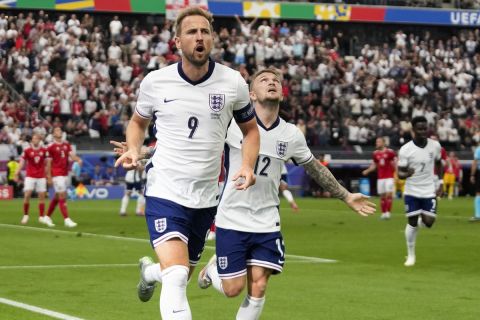 England's Harry Kane (9) celebrates with Kieran Trippier (12) after scoring a goal during a Group C match between Denmark and England at the Euro 2024 soccer tournament in Frankfurt, Germany, Thursday, June 20, 2024. (AP Photo/Themba Hadebe)