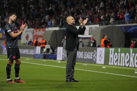 Manchester City's head coach Pep Guardiola applauds supporters at the end of the Champions League group G soccer match between RB Leipzig and Manchester City in Leipzig, Germany, Wednesday, Oct. 4, 2023. (AP Photo/Matthias Schrader)