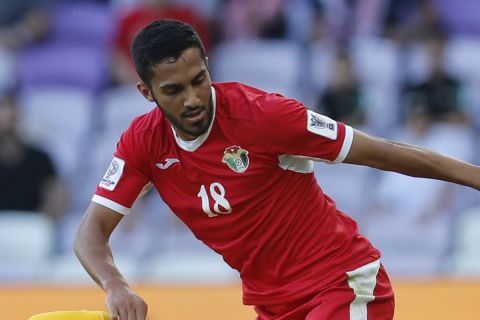 Jordan's midfielder Musa Al-Taamari, top, battles for a ball with Australia's midfielder Massimo Luongo during the AFC Asian Cup group B soccer match between Australia and Jordan at Hazza bin Zayed stadium in Al Ain, United Arab Emirates, Sunday, Jan. 6, 2019. Jordan won 1-0. (AP Photo/Hassan Ammar)