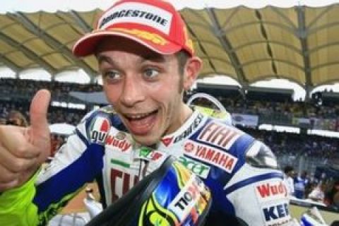 Italian rider Valentino Rossi celebrates after winning the Malaysian Motorcycling Grand Prix at Sepang International Circuit in Sepang, Malaysia, Sunday, Oct. 19, 2008. Newly crowned world champion Rossi won the Malaysian MotoGP on his Yamaha, with Dani Pedrosa riding a Honda finishing a distant second. (AP Photo/Hazrin Yeob Men Shah)