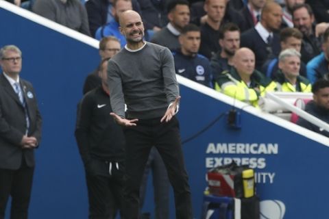 Manchester City coach Pep Guardiola gestures during the English Premier League soccer match between Brighton and Manchester City at the AMEX Stadium in Brighton, England, Sunday, May 12, 2019. (AP Photo/Frank Augstein)