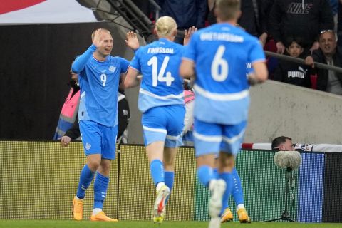 Iceland's Jon Dagur Thorsteinsson,left, celebrates scoring his side's first goal during the International friendly soccer match between England and Iceland at Wembley stadium in London, Friday, June 7, 2024.(AP Photo/Kin Cheung)