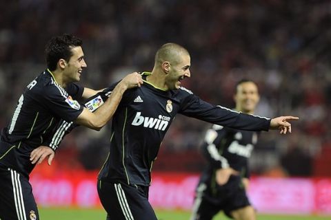 Real Madrid's French forward Karim Benzema (R) celebrates with Real Madrid's defender Alvaro Arbeloa (L) after scoringduring the Spanish King's Cup (Copa del Rey) semifinal first leg football match Sevilla FC vs Real Madrid on January 26, 2011 at the Ramon Sanchez Pizjuan stadium in Sevilla.    AFP PHOTO/ CRISTINA QUICLER (Photo credit should read CRISTINA QUICLER/AFP/Getty Images)