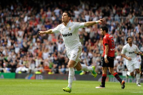 Real Madrid's Portuguese forward Cristiano Ronaldo celebrates after scoring during the Spanish league football match Real Madrid vs Osasuna on November 06, 2011 at the Santiago Bernabeu stadium in Madrid.   AFP PHOTO/ DANI POZO (Photo credit should read DANI POZO/AFP/Getty Images)