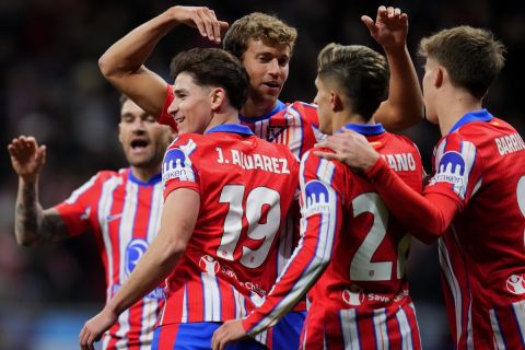 Atletico Madrid's Julian Alvarez (19) celebrates with teammates after scoring the opening goal during the Champions League opening phase soccer match between Atletico Madrid and Slovan Bratislava at Riyadh Air Metropolitano stadium in Madrid, Spain, Wednesday, Dec. 11, 2024. (AP Photo/Manu Fernandez)