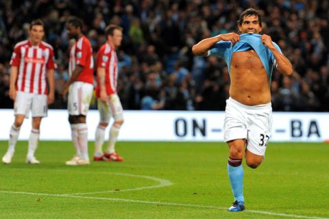 Manchester City's Argentinian forward Carlos Tevez (R) celebrates after scoring the third goal during the English Premier League football match between Manchester City and Stoke City at The City of Manchester stadium, Manchester, north-west England on May 17, 2011. AFP PHOTO/ANDREW YATES.  FOR  EDITORIAL USE Additional licence required for any commercial/promotional use or use on TV or internet (except identical online version of newspaper) of Premier League/Football League photos. Tel DataCo +44 207 2981656. Do not alter/modify photo (Photo credit should read ANDREW YATES/AFP/Getty Images)