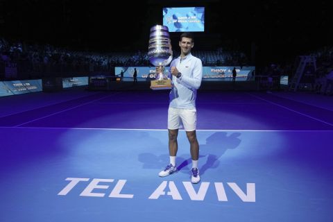 Serbia's Novak Djokovic poses with the trophy after winning the final tennis match of the ATP 250 Tel Aviv open against Croatia's Marin Cilic in Tel Aviv, Israel, Sunday, Oct. 2, 2022. (AP Photo/Ariel Schalit)