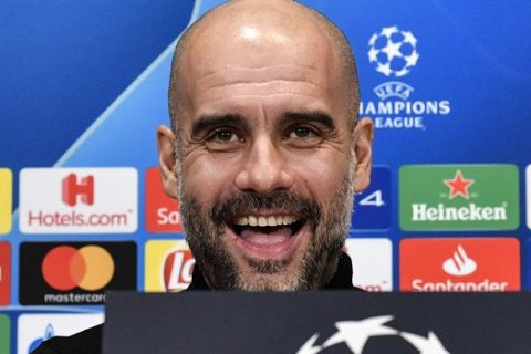 Manchester City manager Pep Guardiola smiles to the media during a press conference prior the Champions League round of 16, first leg, soccer match between FC Schalke 04 and Manchester City in Essen, Germany, Tuesday, Feb. 19, 2019. (AP Photo/Martin Meissner)