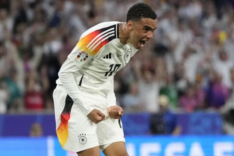 Germany's Jamal Musiala celebrates after scoring his side's second goal during a Group A match between Germany and Scotland at the Euro 2024 soccer tournament in Munich, Germany, Friday, June 14, 2024. (AP Photo/Matthias Schrader)