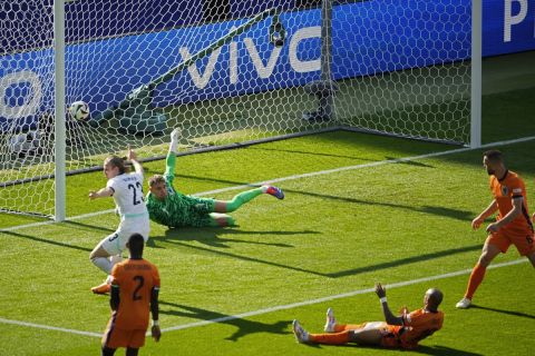 Donyell Malen of the Netherlands, second right, reacts after scoring an own goal during a Group D match between the Netherlands and Austria at the Euro 2024 soccer tournament in Berlin, Germany, Tuesday, June 25, 2024. (AP Photo/Petr David Josek)