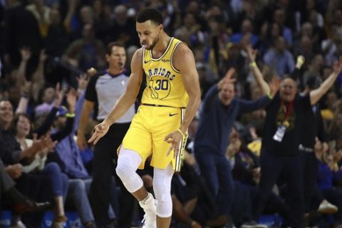 Golden State Warriors' Stephen Curry celebrates a score against the Washington Wizards during the first half of an NBA basketball game, Wednesday, Oct. 24, 2018, in Oakland, Calif. (AP Photo/Ben Margot)