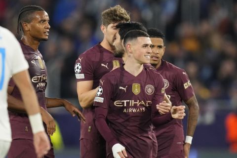 Manchester City's Phil Foden, right, celebrates after scoring his side's second goal during the Champions League opening phase soccer match between Slovan Bratislava and Manchester City in Bratislava, Slovakia, Tuesday, Oct. 1, 2024. (AP Photo/Petr Josek)