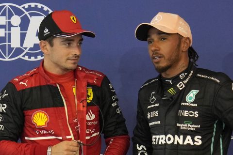 Ferrari driver Charles Leclerc of Monaco, center, who clocked the fastest time, talk with Red Bull driver Sergio Perez of Mexico, left, second fastest, and Mercedes driver Lewis Hamilton of Britain, right, third fastest, after the qualifying session at the Singapore Formula One Grand Prix, at the Marina Bay City Circuit in Singapore, Saturday, Oct. 1, 2022. (AP Photo/Vincent Thian)