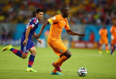 RECIFE, BRAZIL - JUNE 14: Yaya Toure of the Ivory Coast controls the ball against Hotaru Yamaguchi of Japan during the 2014 FIFA World Cup Brazil Group C match  between the Ivory Coast and Japan at Arena Pernambuco on June 14, 2014 in Recife, Brazil.  (Photo by Julian Finney/Getty Images)