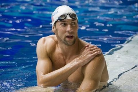 U.S. swimmer Michael Phelps warms up prior to competing in the 100 meter butterfly event at the Canada Cup swim meet in Montreal, Sunday, July 3, 2011.(AP Photo/The Canadian Press, Graham Hughes)