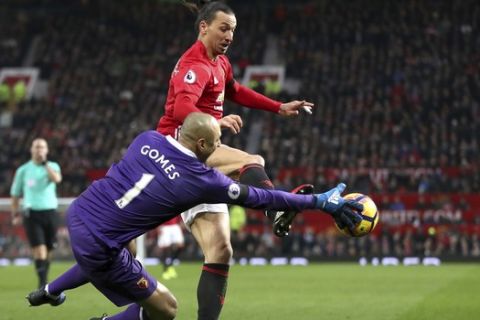 Manchester United's Zlatan Ibrahimovic, background and Watford goalkeeper Heurelho Gomes vie for the ball, during the English  Premier League soccer match between Manchester United and Watford, at Old Trafford, in Manchester, England, Saturday, Feb. 11, 2017. (Nick Potts/PA via AP)