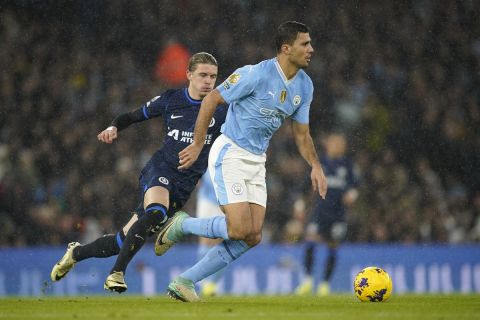 Chelsea's Conor Gallagher chases Manchester City's Rodri during the English Premier League soccer match between Manchester City and Chelsea at the Etihad stadium in Manchester, England, Saturday, Feb. 17, 2024. (AP Photo/Dave Thompson)