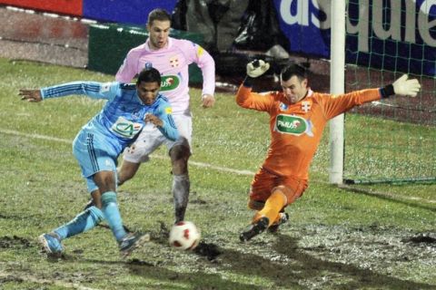 Marseille's Brazilian forward Lemos Brandao (L) shoots the ball against Evian's French French goalkeeper Quentin Westberg (R) and  midfielder Pierre Bouby (C) during on January 9, 2011  at the Parc des Sports in Annecy, central eastern France. AFP PHOTO/PHILIPPE DESMAZES (Photo credit should read PHILIPPE DESMAZES/AFP/Getty Images)