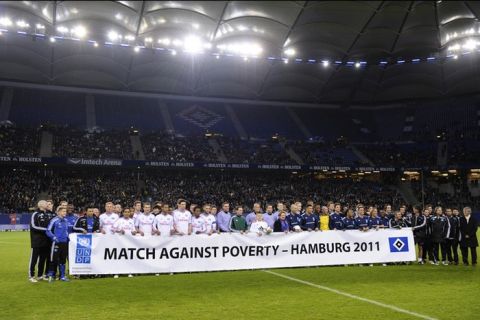 Players pose prior to the "Match Against Poverty" friendly charity football in support of Horn of Africa famine relief led by the United Nations Development Programme (UNDP) between an all-star side of Hamburger SV and a selection of other International players including UNDP Goodwill Ambassadors Ronaldo and Zidane in the northern German city of Hamburg on December 13, 2011.  AFP PHOTO / OLIVER HARDT (Photo credit should read OLIVER HARDT/AFP/Getty Images)