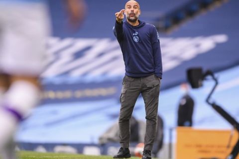 Manchester City's head coach Pep Guardiola gestures during the English Premier League soccer match between Manchester City and Bournemouth at the Ethiad Stadium in Manchester, England, Wednesday, July 15, 2020. (Laurence Griffiths/Pool via AP)