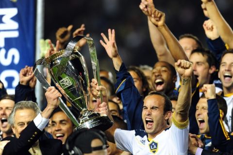 MVP and game-wining goal scorer Landon Donovan (R) lifts the winning trophy following victory over the Houston Dynamo in their MLS Cup final at the Home Depot Center in Carson, California on November 20, 2011.  The LA Galaxy defeated the Houston Dynamo 1-0. AFP PHOTO / Frederic J. BROWN (Photo credit should read FREDERIC J. BROWN/AFP/Getty Images)