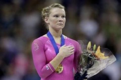 Gold medalist Bridget Sloan of the U.S. listens to her national anthem during the medal ceremony for the World Gymnastics Championships women's all-around final at the O2 Arena in London, Friday, Oct. 16, 2009 (AP Photo/Matt Dunham)