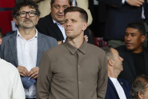 Wojciech Szczesny, centre, a new goalkeeper for Barcelona is on stands during the Champions League soccer match between Barcelona and Young Boys at the Lluis Companys Olympic Stadium in Barcelona, Spain, Tuesday, Oct. 1, 2024. (AP Photo/Joan Monfort)