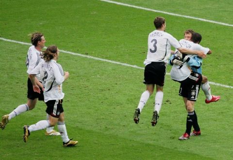 BERLIN - JUNE 30: Jens Lehmann of Germany is mobbed by his team mates following his decisive save of Esteban Cambiasso's penalty to give his team victory in a penalty shootout at the end of the FIFA World Cup Germany 2006 Quarter-final match between Germany and Argentina played at the Olympic Stadium on June 30, 2006 in Berlin, Germany.  (Photo by Alex Livesey/Getty Images)