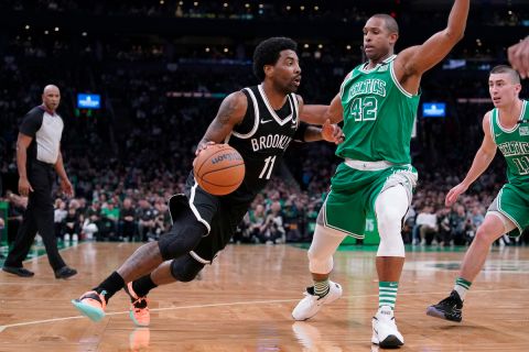 Brooklyn Nets guard Kyrie Irving (11) tries to drive past Boston Celtics center Al Horford (42) in the second half of an NBA basketball game, Sunday, March 6, 2022, in Boston. The Celtics won 126-120 over the Nets. (AP Photo/Steven Senne)