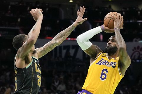 Los Angeles Lakers forward LeBron James shoots over Charlotte Hornets forward P.J. Washington during the first half of an NBA basketball game between the Charlotte Hornets and the Los Angeles Lakers on Monday, Jan. 2, 2023, in Charlotte, N.C. (AP Photo/Chris Carlson)