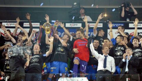 The players of FC Basel celebrate with the trophy after the Super League soccer match between FC Basel and FC Lucerne at the St. Jakob-Park stadium in Basel, Switzeland, Wednesday, May 25, 2011. (KEYSTONE/Walter Bieri)