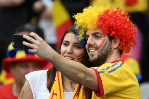 Romania supporters take a selfie before the start of the Euro 2016 group A football match between France and Romania at Stade de France, in Saint-Denis, north of Paris, on June 10, 2016.  / AFP PHOTO / FRANCISCO LEONG