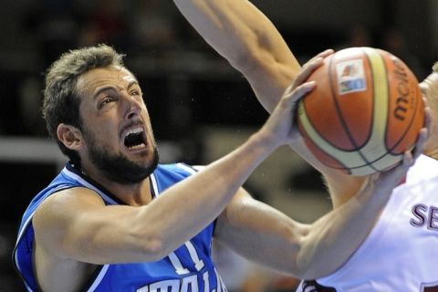 Italy's Marco Belinelli vies with a Latvian player during the first round Group B qualifying match between Italy and Latvia in Siauliai on September 2, 2011, on the third day of the EuroBasket 2011.  AFP PHOTO / JANEK SKARZYNSKI (Photo credit should read JANEK SKARZYNSKI/AFP/Getty Images)